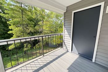 the view from the balcony of a home with a large screen door at Deercross Apartments, Cincinnati, OH